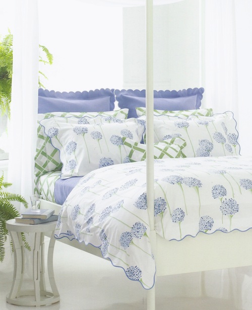 Blue and green patterned pillows and duvet on bed